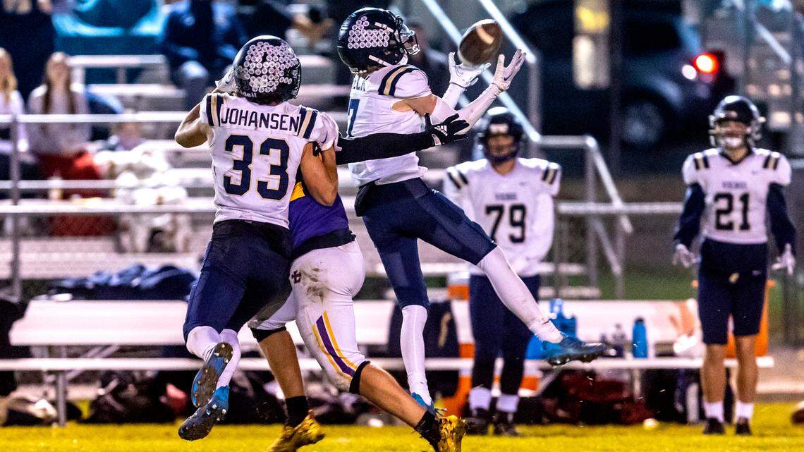 Middleton defensive back Sawyer Heck intercepts a pass intended for Lewiston tight end James White during 5A state playoff game in Lewiston on Friday.