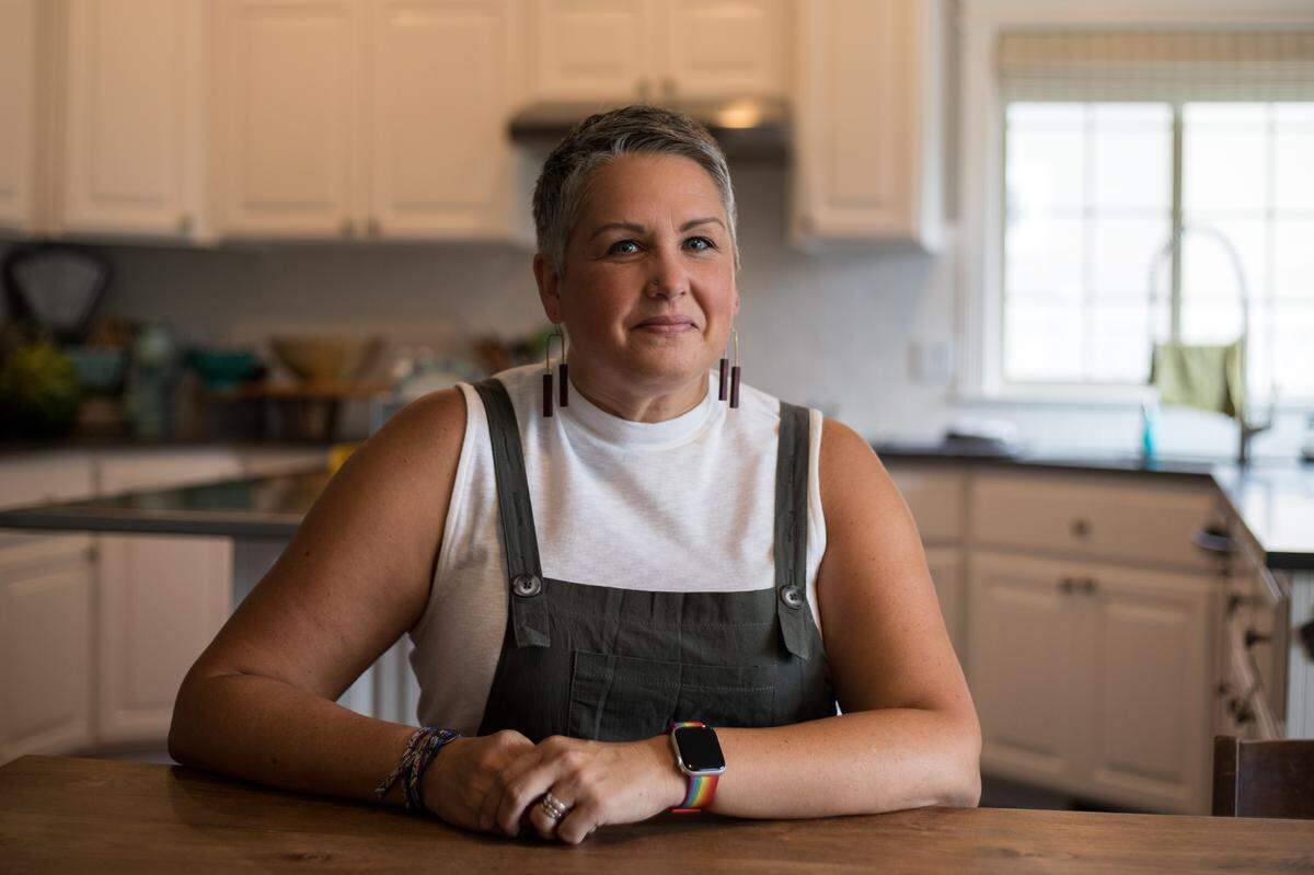Sunny Ernst-Smart sits for a portrait in the kitchen of her home in Meridian. After nearly 20 years of marriage and four children, Sunny Ernst Smart came out to her family as gay last October. Now, Smart holds workshops where LDS leaders can come, ask questions without judgment and learn about how to include LGBTQ individuals within the LDS community.