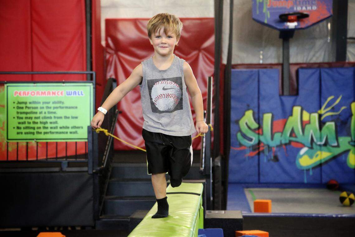 Bradley Pittard, 4, runs on a balance beam positioned between two pits with soft foam blocks at JumpTime in Meridian.