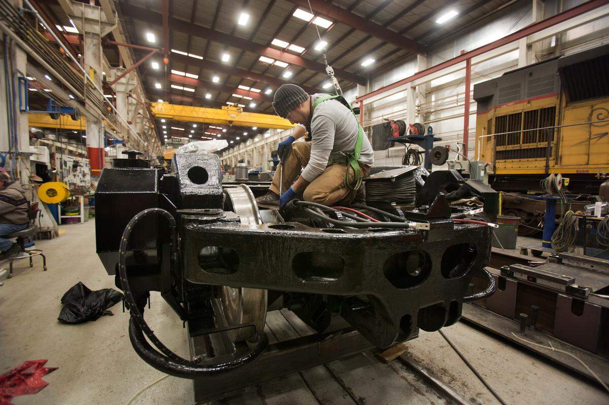 Leo Martinez, finish shop artist, works on the electric hookups of the “bogie,” the “truck” part of an engine bound in 2012 for a customer, CGH Group, in Australia.