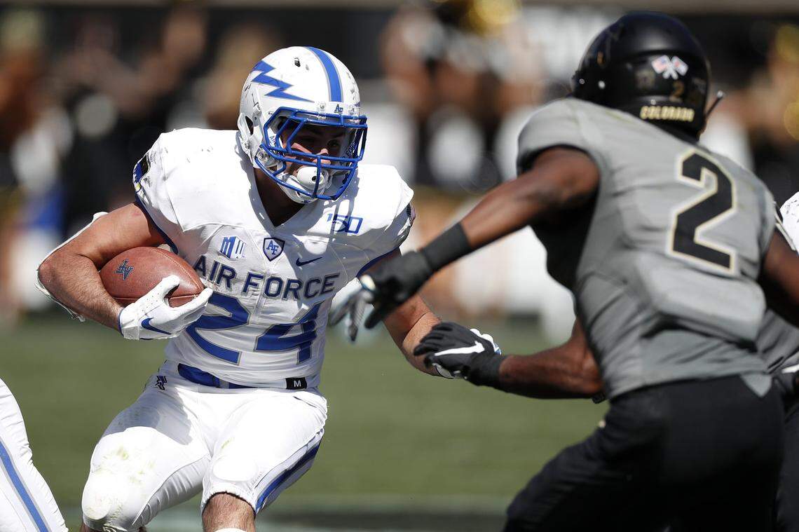 Air Force running back Kadin Remsberg, left, runs the ball as Colorado safety Mikial Onu comes in for the tackle in the second half of an NCAA college football game Saturday, Sept. 14, 2019, in Boulder, Colo. Air Force won 30-23 in overtime. (AP Photo/David Zalubowski)