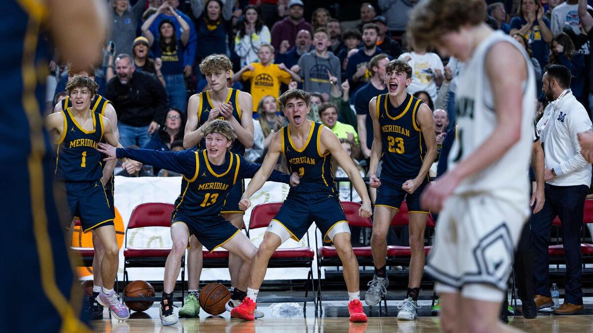 Meridian’s bench celebrates a teammate after he scores and draws a foul in a 71-68 win over Mountain View in the 5A boys basketball state tournament semifinals Friday at the Ford Idaho Center in Nampa.