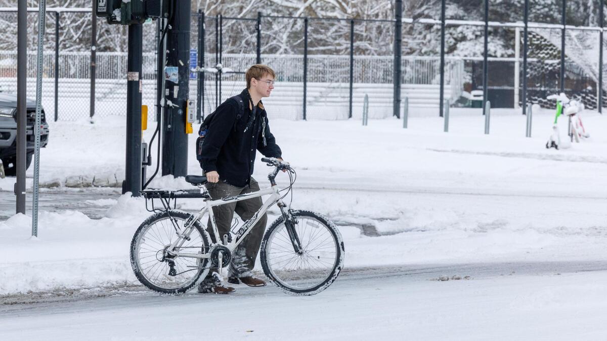 People traverse the sidewalks at Boise State University during a snow day Wednesday.