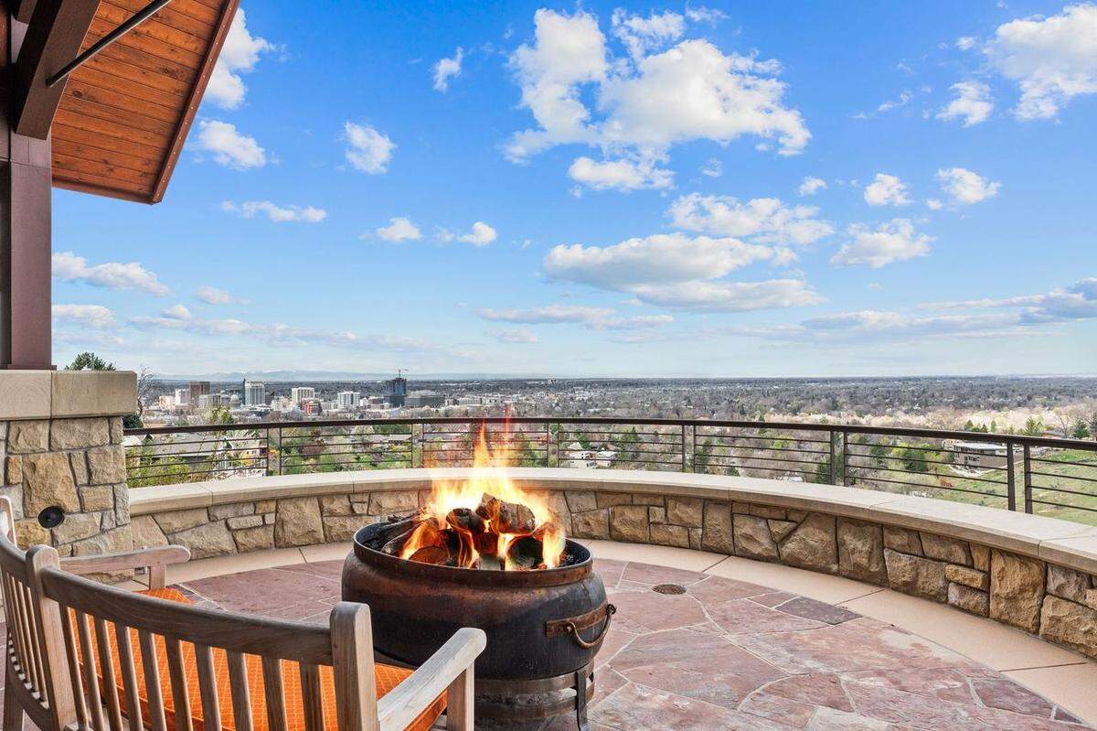 The spacious deck features a large firepit and offers views over the foothills.