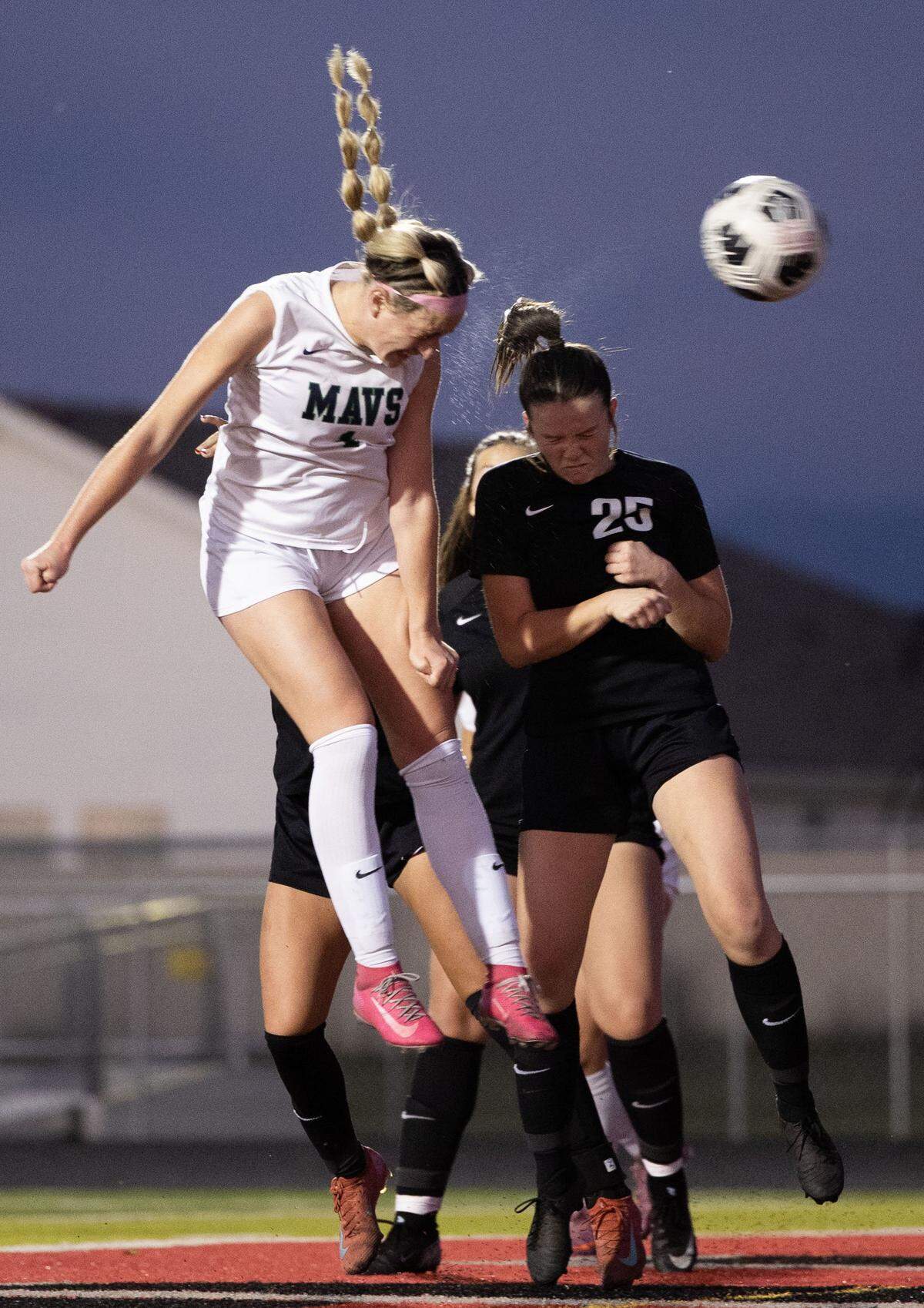 Mountain View forward Samantha Jones directs a corner kick header toward the goal, defended by Boise's Eden Scott in the 6A District Three girls soccer championship game. The shot was not successful. Boise won the title game 2-1 at Owyhee High School in Meridian, Wednesday, Oct. 15, 2025.