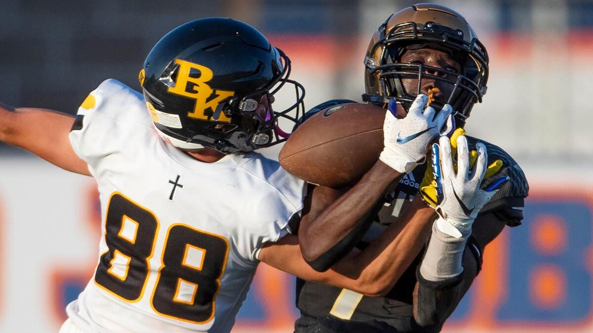 Bishop Kelly defensive back Noah Bornes, left, breaks up a pass in the end zone intended for Capital’s Victor Byaundaombe on Thursday at Dona Larsen Park in Boise. The Knights dominated Capital 41-6 in the first meeting between the two programs.