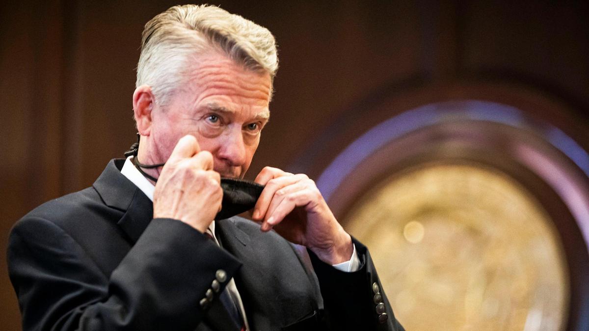 Gov. Brad Little replaces his protective mask after officially extending Stage 4 of Idaho’s COVID-19 reopening plan, Thursday, June 25, 2020 at the Statehouse in Boise. During a news conference, Gov. Little said Idaho had not met the metrics to move forward in preventing spread of the coronavirus.
