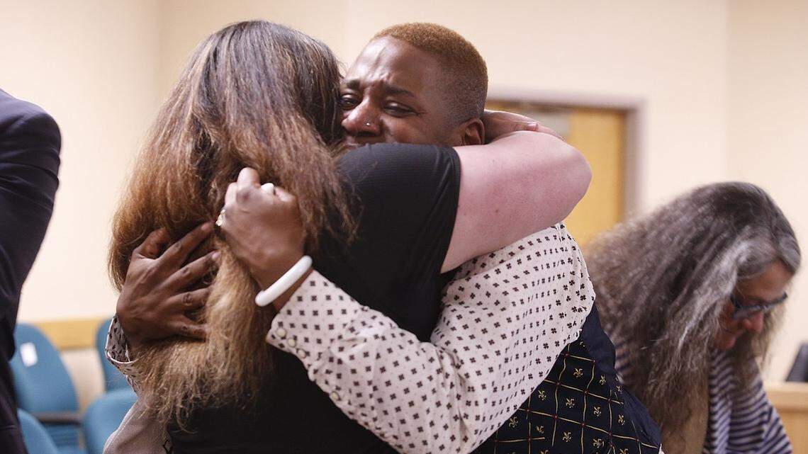 Eric Posey, right, tearfully embraces a supporter after a jury awarded him more than $1.1 million in damages for defamation in May at the Kootenai County District Court in Coeur d’Alene.