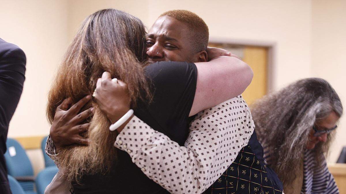 Eric Posey tearfully embraces a supporter after the jury awarded him more than $1.1 million in damages for defamation.