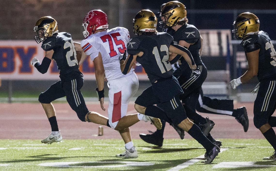 Capital’s Brody Call scoops up a blocked punt for the game-winning touchdown in a 35-21 victory over Nampa on Thursday at Dona Larsen Park in Boise.