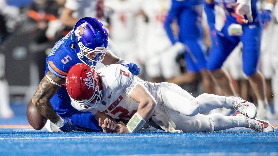 Boise State’s Jayden Virgin-Morgan forces a fumble by New Mexico quarterback Jack Layne in the first quarter Saturday night. The Broncos harassed Layne, an Idaho Vandals transfer, into a rough game.