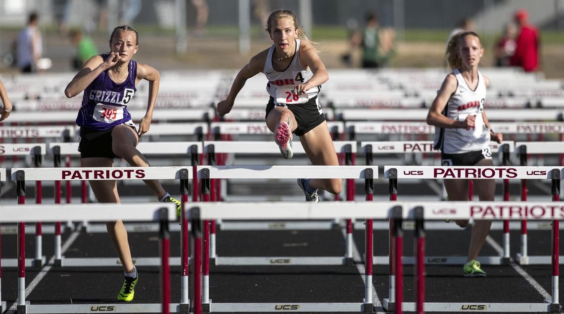 Boise High’s Linden Carter, center, competes with Kenna Jones of Rocky Mountain, and teammate Kayden Hulquist, right, in the girls 100-meter hurdles during the 5A District Three track and field championships May 10 at Centennial High.