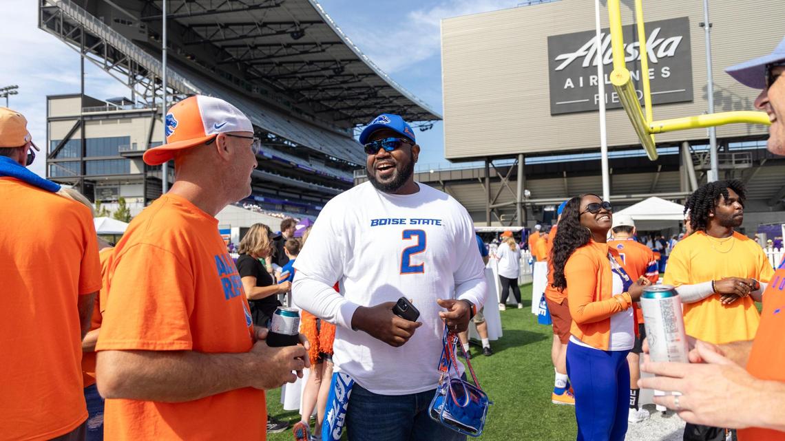Richard Gervais, center, uncle of Boise State running back Ashton Jeanty, talks with fellow tailgaters outside Husky Stadium.