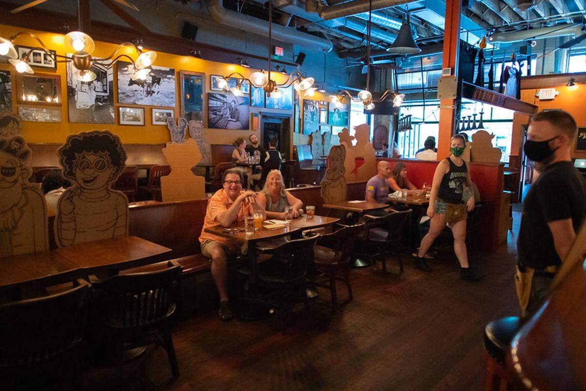 Customers enjoy food and drink during a soft opening Saturday at Bittercreek Alehouse.