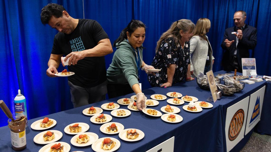 Waffle Me Up owner Hector Garcia and his wife, Josie Garcia, serve waffles at the open house.