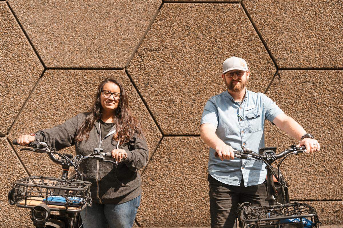 Nely Hurtado and Connor O’Hora ride bikes for a summer homeless outreach effort. The two are part of CATCH’s homeless-outreach team that distributes information and goods to Boise’s homeless population.