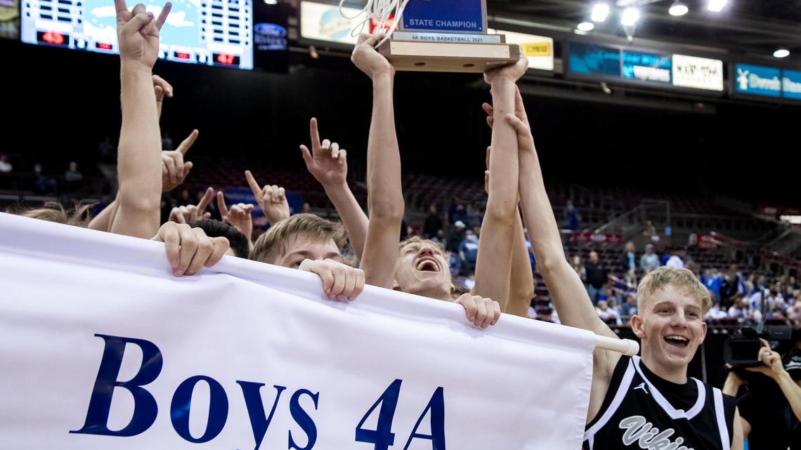 Middleton junior Tyler Medaris screams as he lifts the 4A boys basketball state championship trophy into the air after the Vikings defeated Preston 47-45 for the title Saturday at the Ford Idaho Center in Nampa.