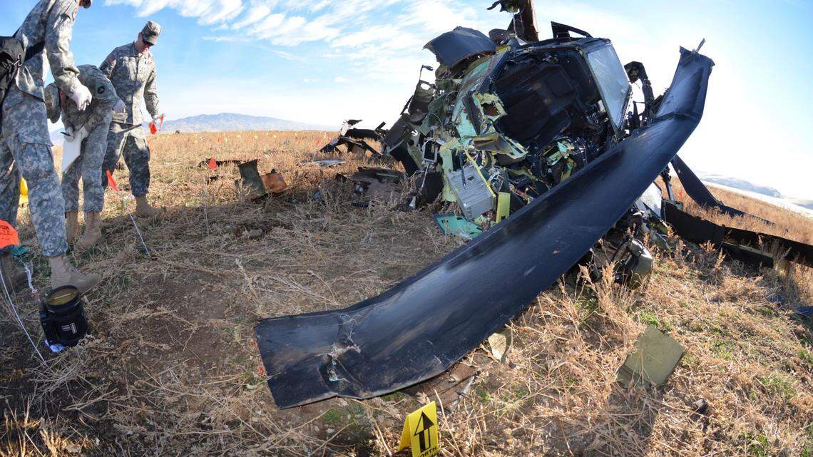 U.S.Army investigators sort through the remains of the Apache helicopter that crashed in a field south of Boise on Nov. 6, 2014, killing Idaho Army National Guard pilots Jon Hartway and Stien Gearhart. Fellow members of the Idaho Guard said that Gearhart and Hartway, both of whom served in combat in Afghanistan, were top-notch pilots.