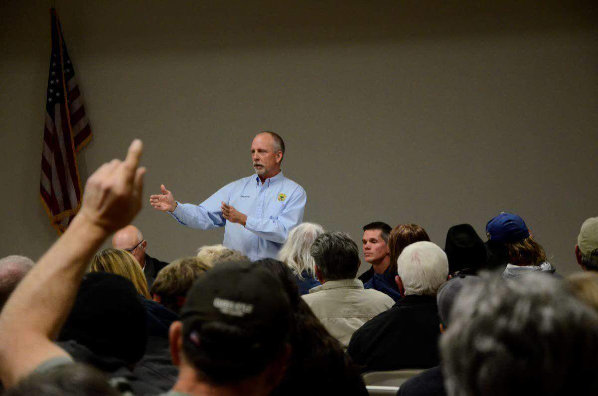 Ed Schriever, deputy director of the Idaho Department of Fish and Game, addresses audience members at a community meeting in Riggins over the looming suspension of the steelhead season in Idaho.