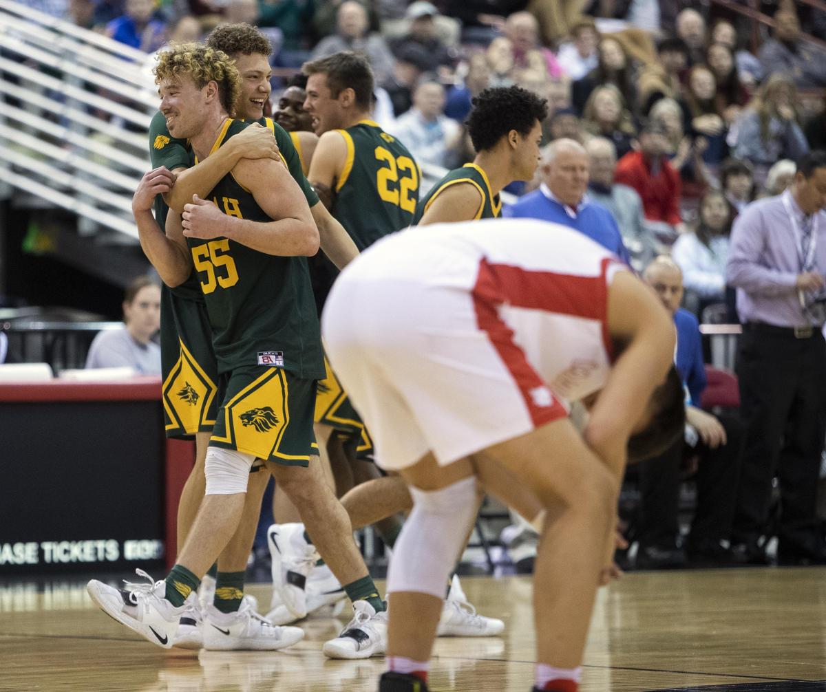 Borah seniors Ellis Magnuson and Caleb Golden hug at midcourt as starters head for the bench with the game in hand against Madison in the state 5A boys basketball championship Saturday, March 2, 2019 at Ford Idaho Center in Nampa.