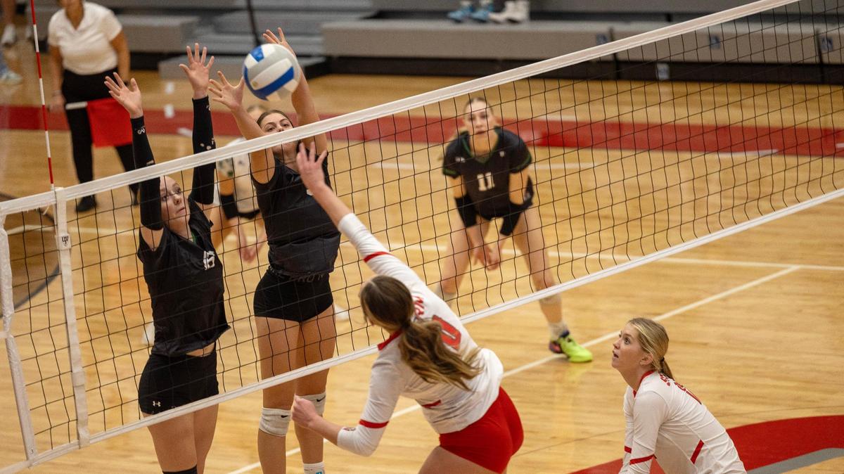 Owyhee junior Makaiya Gerhardt spikes the ball past Eagle’s seniors Teagan Scott, left, and Liv Manning during the 5A District Three Tournament championship match, Thursday.