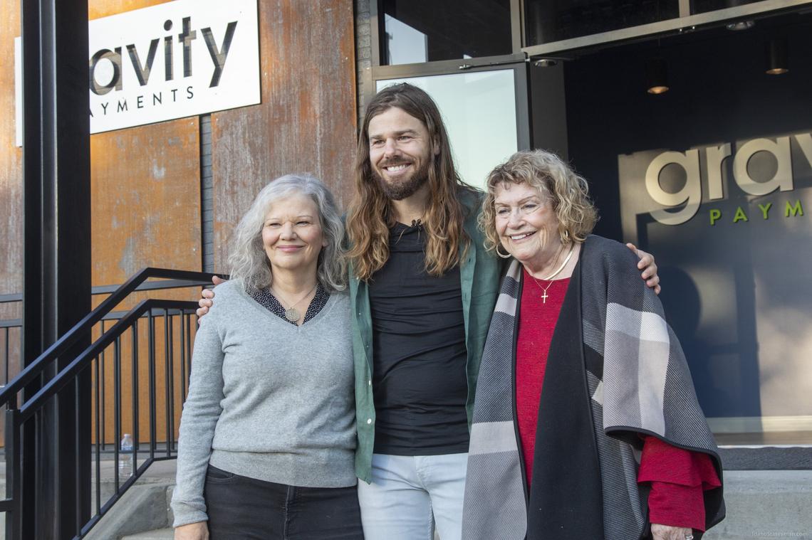 Dan Price, CEO of Gravity Payments, said business has improved enough to restore pay cuts that his employees volunteered to take following the coronavirus pandemic. He is shown with his mother, Pamela Price, left, and his grandmother, Patricia Lucas, during the opening last September of the company’s Boise office..