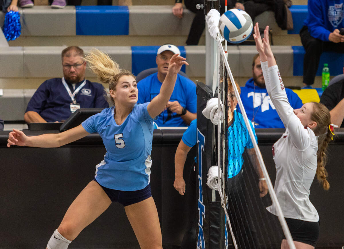 Skyview outside hitter Bellamie Beus tips the ball past Columbia setter Mandi Nottingham on Saturday.