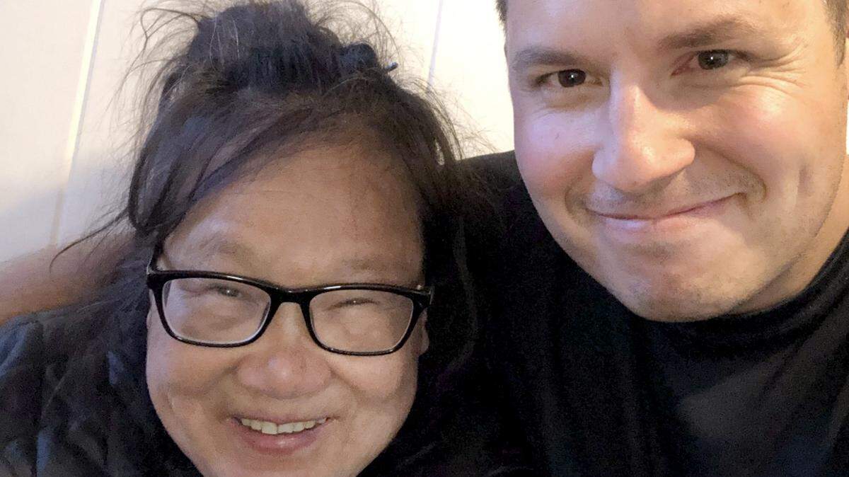 Jesse Broyles stands with Helen Wong, whom he helped after the 70-year-old’s Lewiston home was left destitute by looters while she was stranded in China by the coronavirus pandemic.
