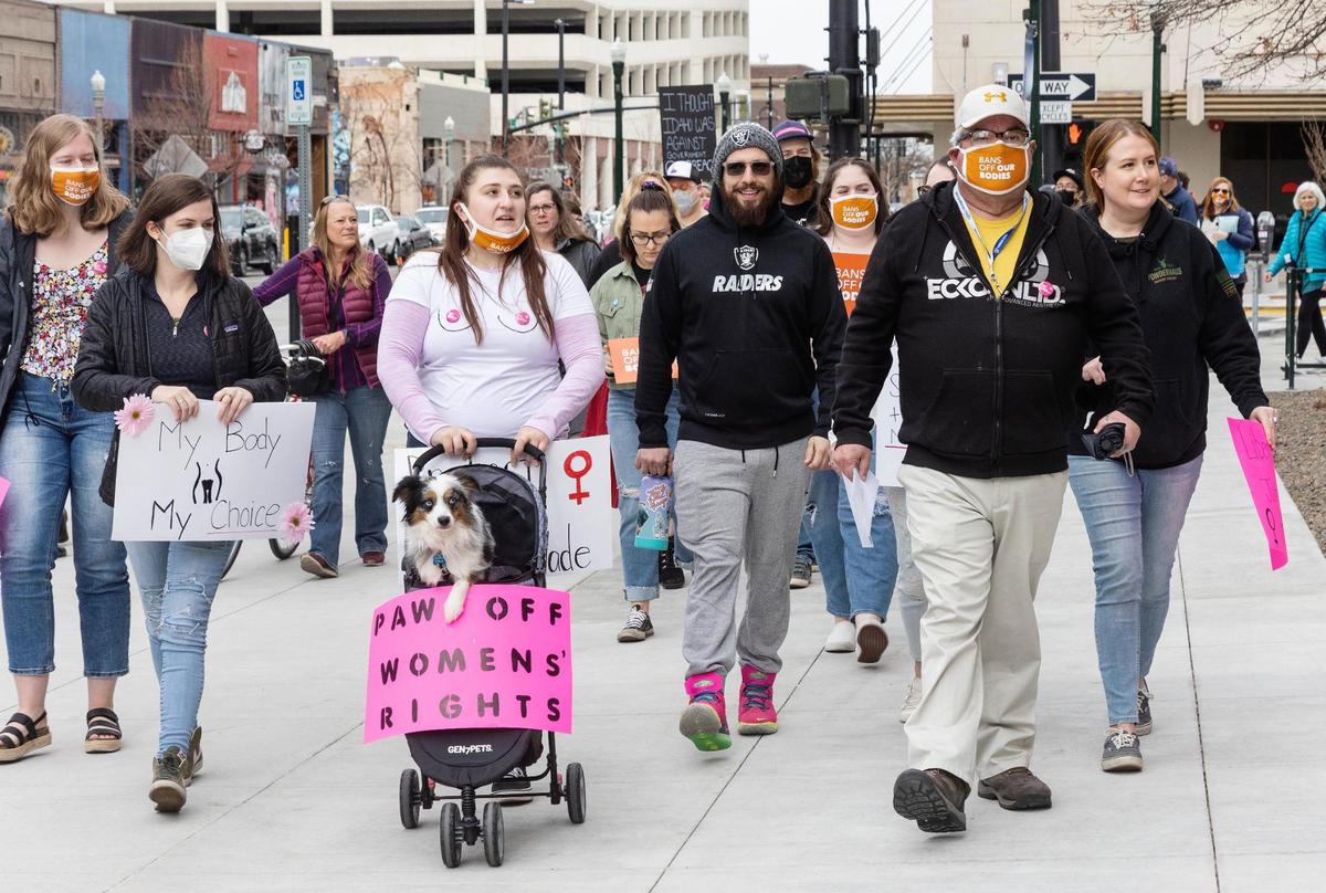 People walked in March to the post office in downtown Boise to mail letters to Gov. Brad Little to call on him to veto Idaho’s restrictive new abortion law. The governor signed the bill, despite concerns it might be unconstitutional.