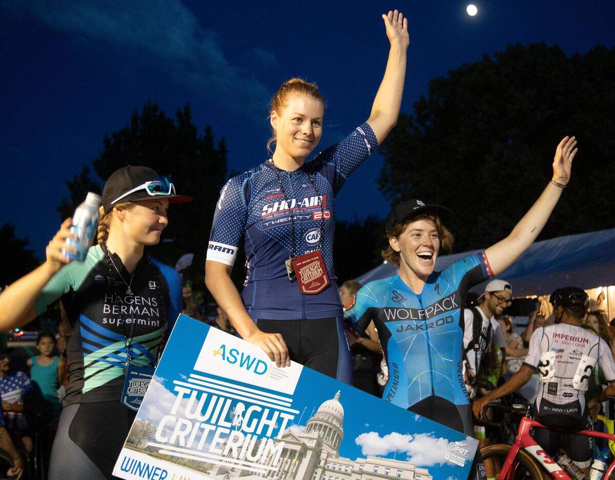 Jennifer Valente, center, celebrates her first place on the podium with Harriet Owen, left, second, and Abigail Youngwerth, right. The 2019 Boise Twilight Criterium on Saturday, July 13, in Downtown Boise.