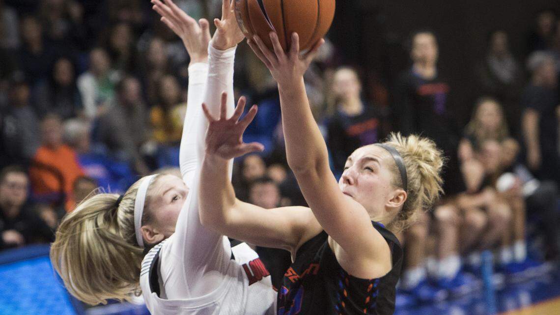 Boise State’s Ellie Woerner is fouled by Louisville’s Sam Fuehring. The No. 5 Cardinals defeated the Broncos 74-55 on Monday at Taco Bell Arena.