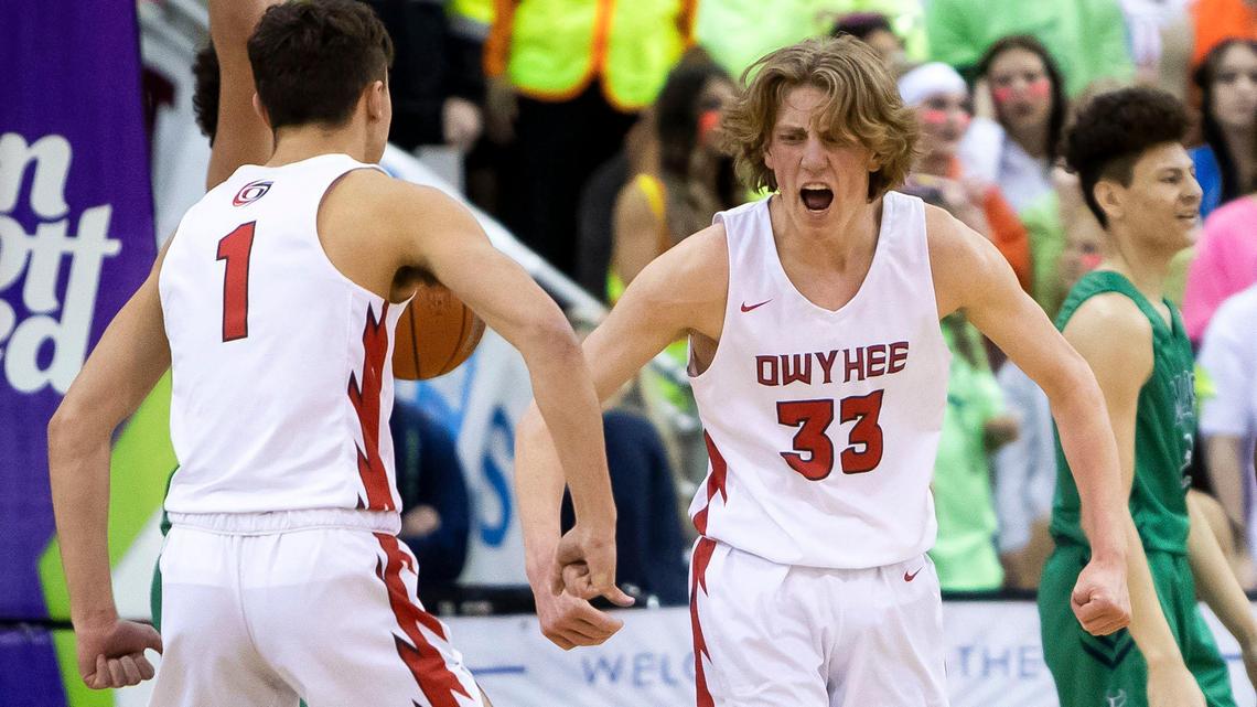 Owyhee guard Liam Campbell, right, and teammate Cameron Downie flex after Campbell scores while being fouled during the first round of the 5A boys basketball state tournament Thursday at the Ford Idaho Center in Nampa. Owyhee defeated Mountain View 56-45.