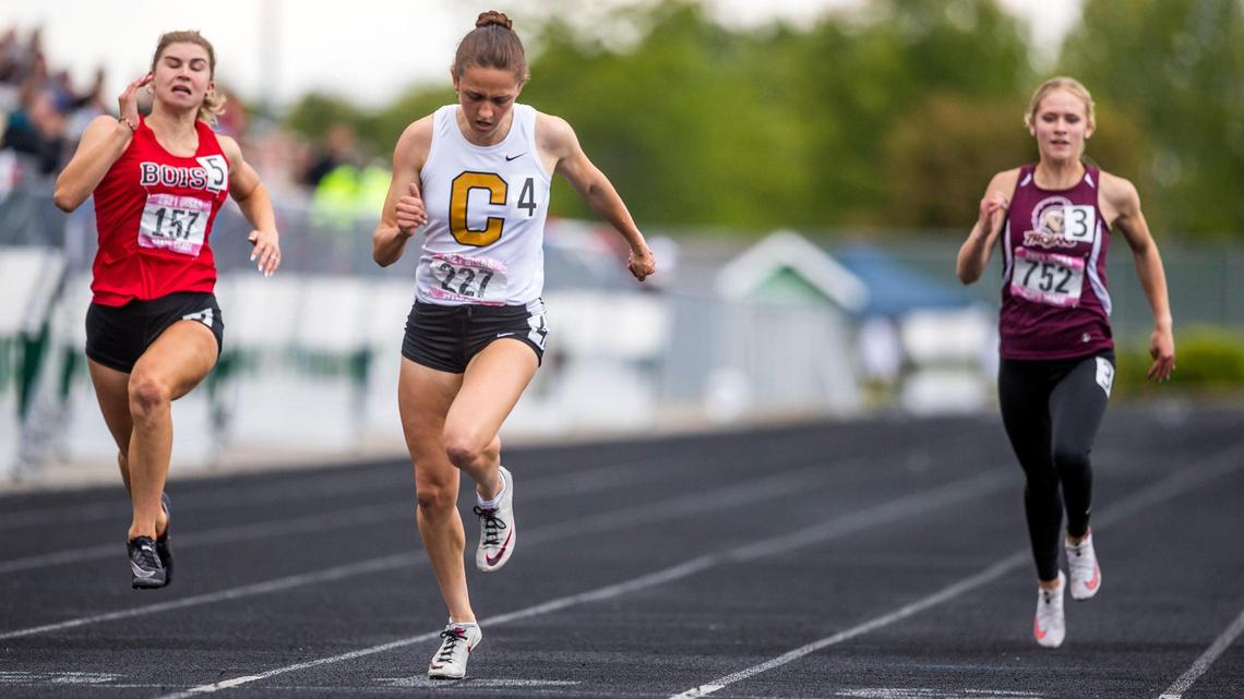 Megan Rose, Capital, crosses the 100-meter finish line in 12.02, setting a new state record during the 5A girls state track finals Saturday, May 22, 2021, at Eagle High School. Asia Lawyer, right, of Centennial finished second and Boise’s Audrey Smith third.