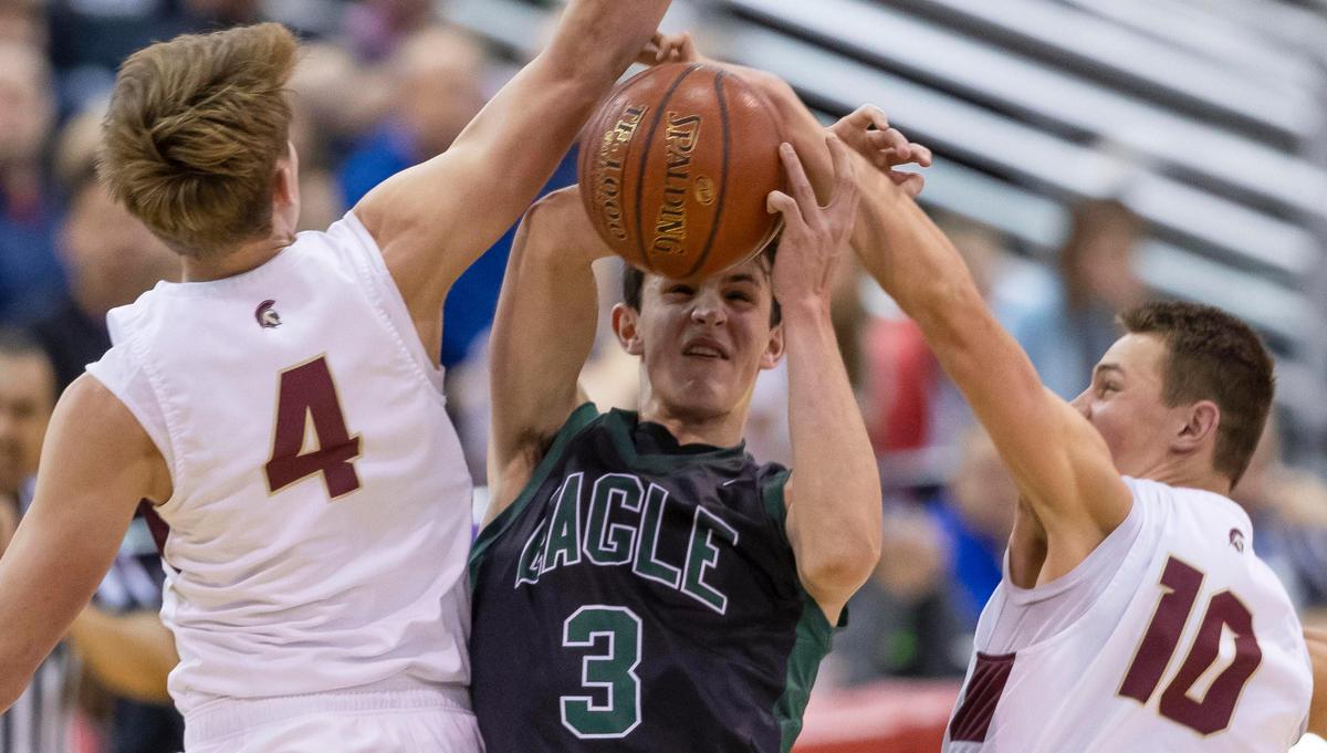 Eagle senior Tanner Hayhurst is fouled by Rigby’s Keegan Thompson in the first round of the 5A state boys basketball tournament Thursday, March 5, 2020 at Ford Idaho Center in Nampa.