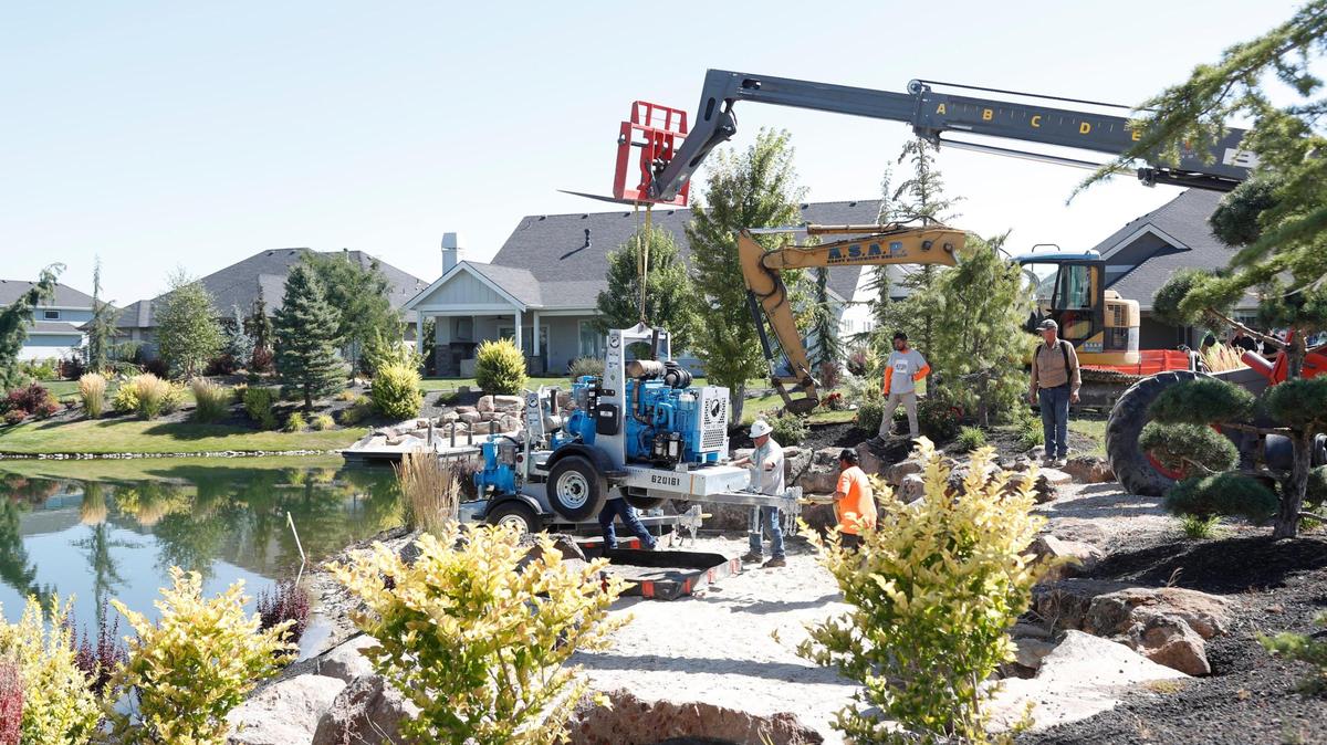 Contractors set pumps in place to drain a pond near where 2-year-old Rory Pope disappeared on Wednesday.