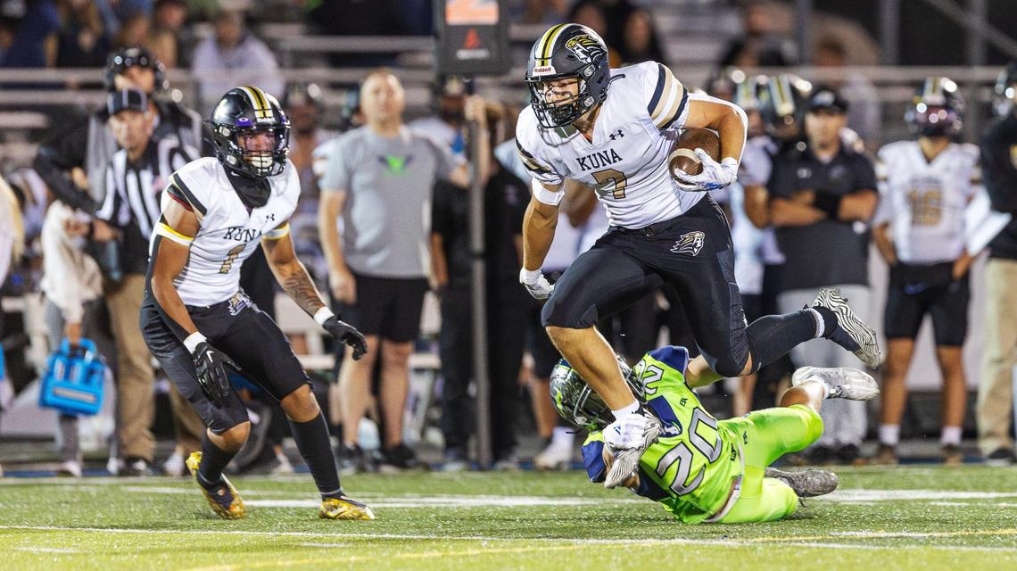 Kuna senior wide receiver Luke Selto is dragged down by Mountain View senior defensive back Torry Whiles in the third quarter Friday at Mountain View.