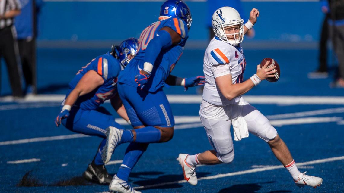 Boise State quarterback Jack Sears tries to evade nose tackle Scale Igiehon, but the Bronco defense is credited with a sack during the 2021 spring game on Saturday, April 10, 2021, at Albertsons Stadium in Boise.