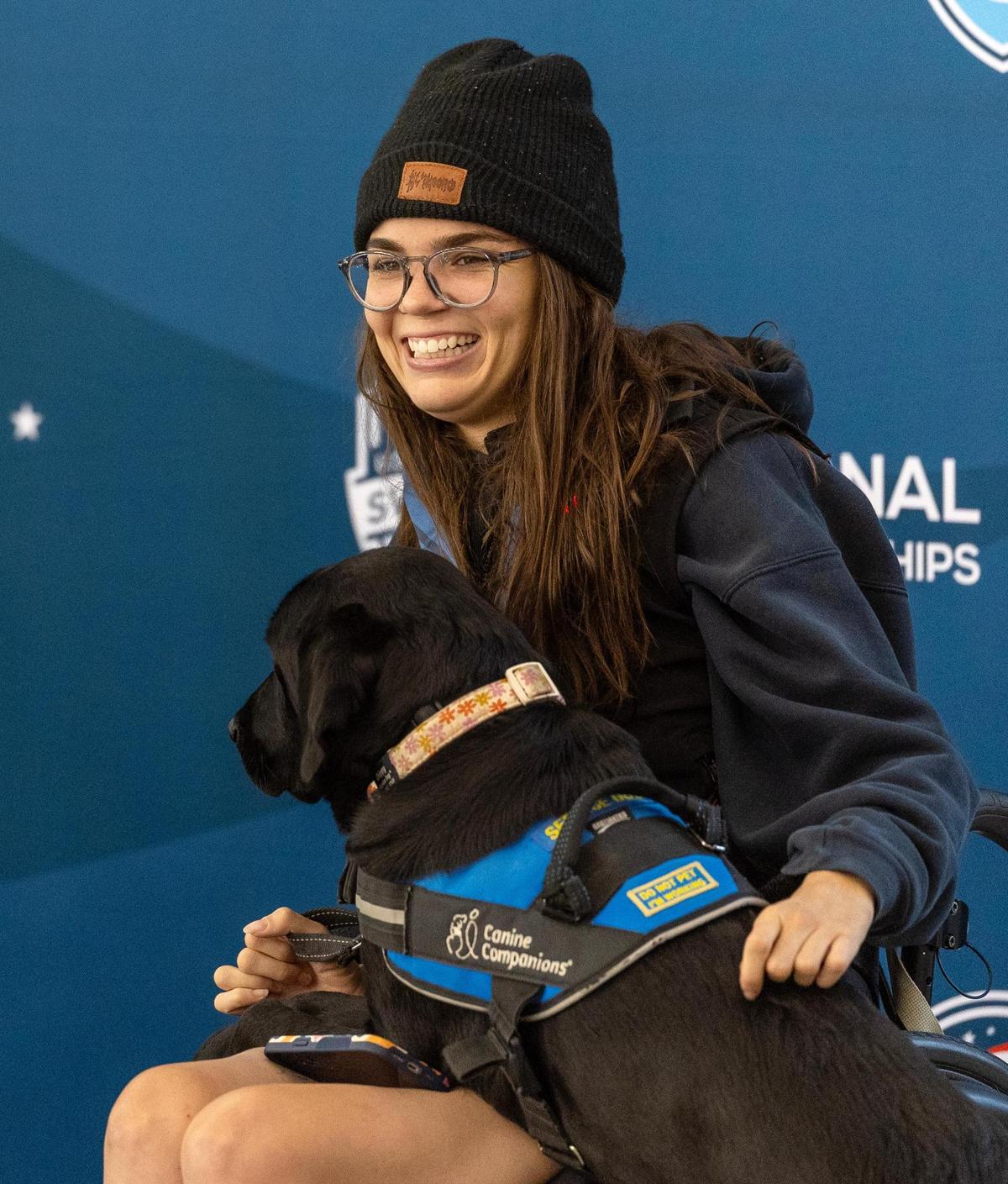 Eden Schroeder and her service dog Chippy pose for a photo after Schroeder received a bronze medal in the women’s 50-meter backstroke at the 2025 U.S. Paralympics Swimming National Championships at the Idaho Central Aquatic Center in Boise.