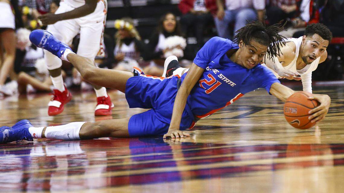 Boise State guard Derrick Alston and UNLV guard Noah Robotham battle for a loose ball during the second half of their game Saturday at the Thomas & Mack Center in Las Vegas. The Rebels won 85-81 in overtime.