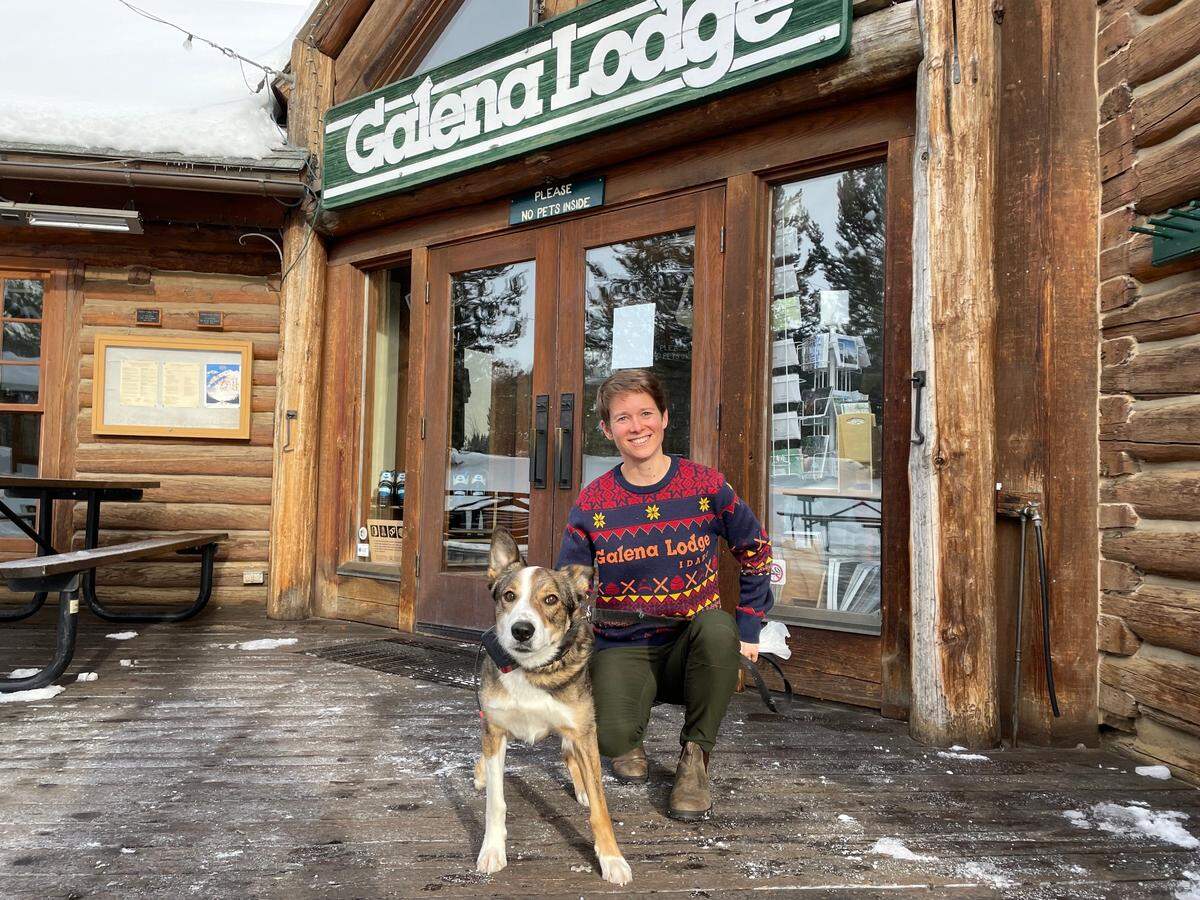 Rio the Galena Lodge “loaner dog” poses on the deck outside the lodge with his owner, Chelan Oldemeyer, on Friday, Jan. 26, 2024. Chelan and her husband, Kyle, run the county-owned lodge as concessionaires.