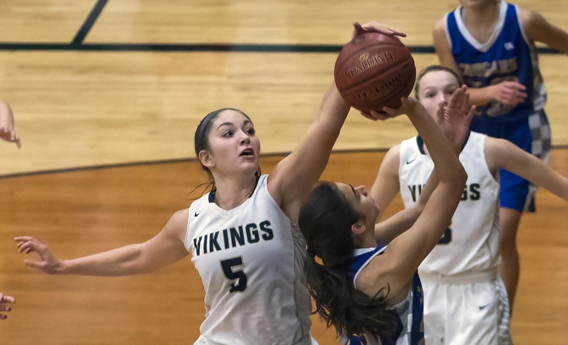 Middleton senior Lexi Mitchell blocks a layup by Caldwell’s Belle Bower in last week’s 4A district title game.