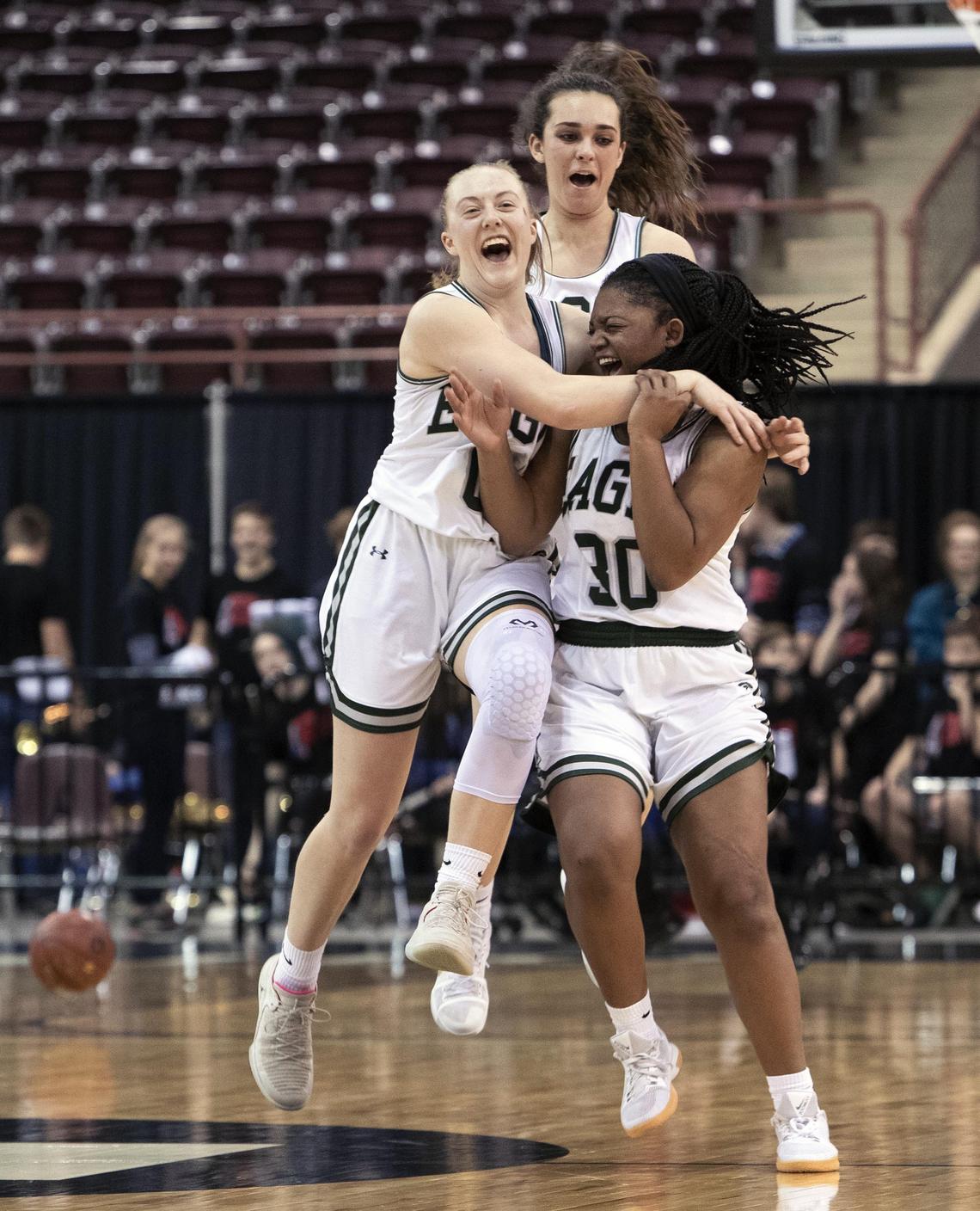 Eagle seniors Meghan Boyd, Jaimee McKinnie and Gabi Peters celebrate their 61-55 win over Boise in the 5A girls basketball state tournament Friday at the Ford Idaho Center.