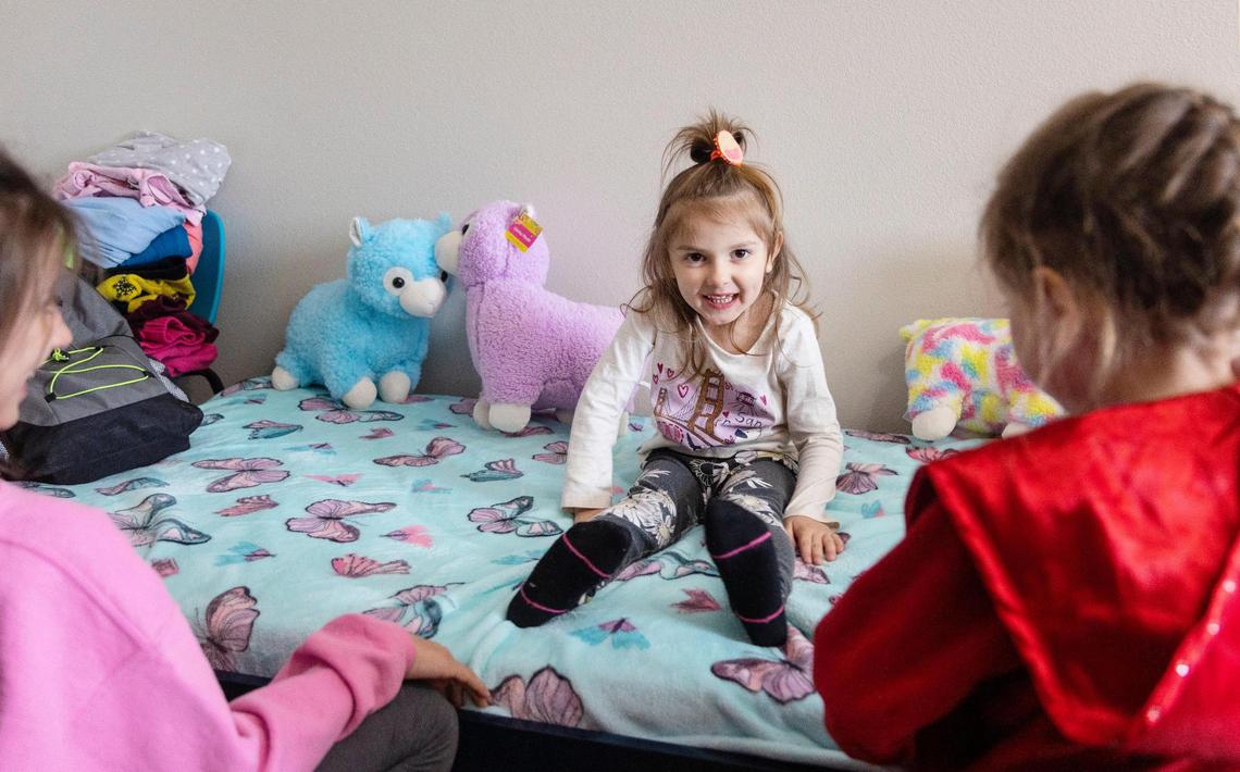 Vanessa, 4, center, and her sisters play in the room they are staying in with a host family in Kuna. Their family of six fled the Ukraine after the Russian invasion.