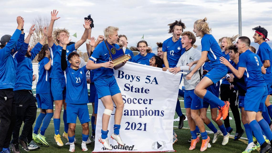 Timberline defender Luke Pepin holds the trophy as the Wolves celebrate winning the 5A boys soccer state championship Saturday at Eagle High School.