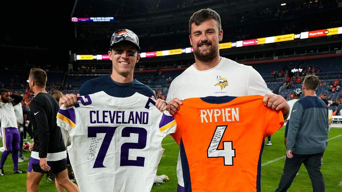 Denver Broncos quarterback Brett Rypien, left, and Minnesota Vikings offensive lineman Ezra Cleveland pose for a photo after the Broncos’ 23-13 preseason win over the Vikings on Saturday.