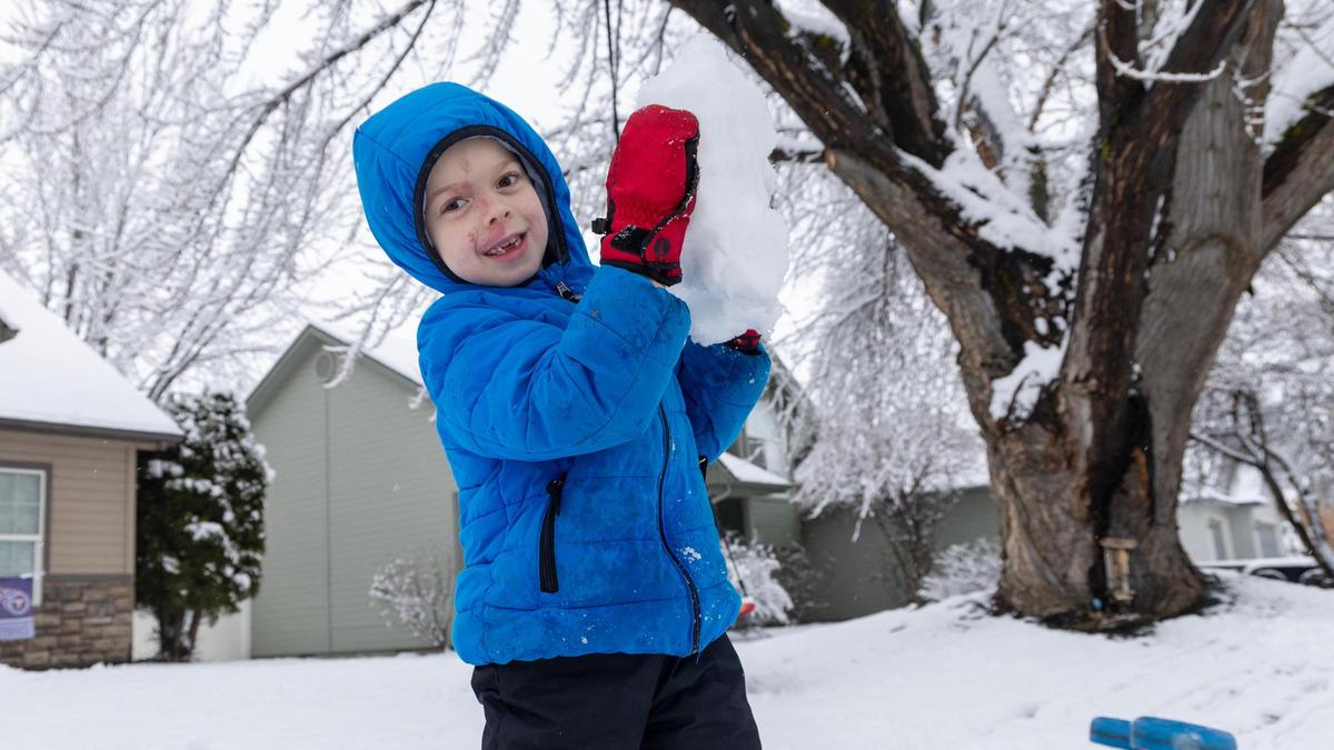 Holland Bullock. 5, plays in the snow at his home Friday in Meridian.