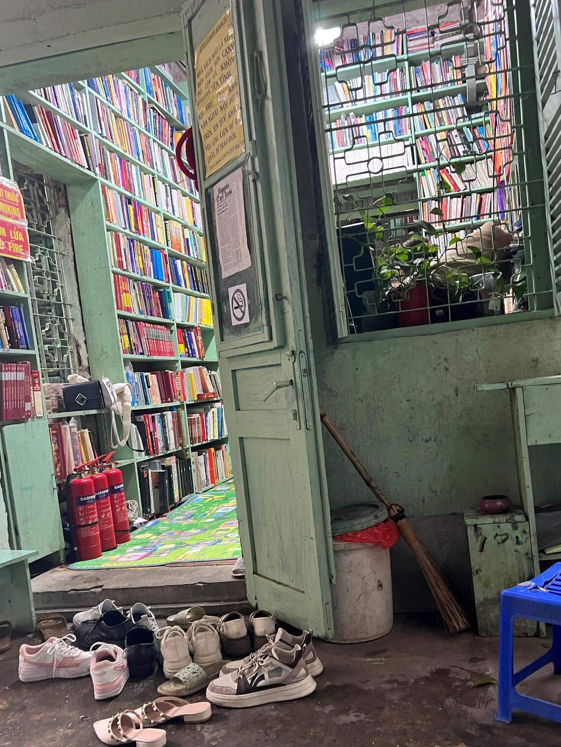 Customers remove their shoes to enter the two-story wooden shop.