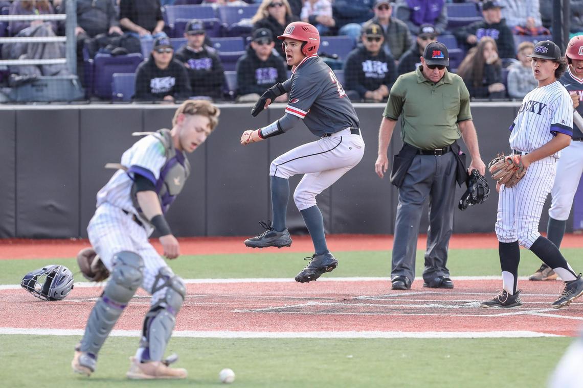 Owyhee’s Cole Rohlmeier celebrates after scoring the opening run on a wild pitch Saturday in the 5A state championship at Wolfe Field in Caldwell.