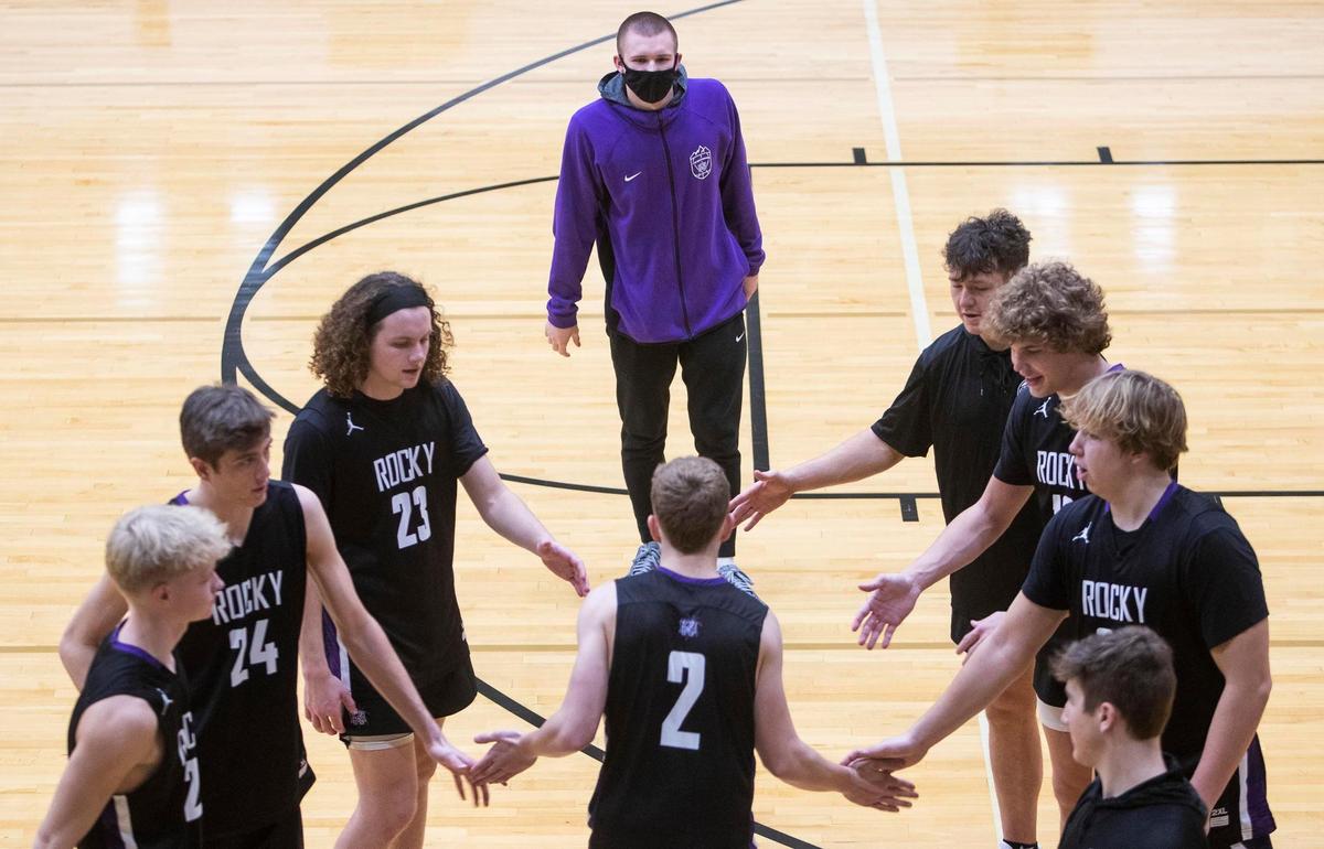 Senior Jaden Hansen greets his teammates as Rocky Mountain’s starting lineup is announced Friday at Capital High.