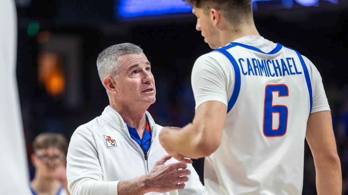 Boise State head coach Leon Rice talks to forward Pearson Carmichael in the Broncos’ Mountain West game against New Mexico at ExtraMile Arena in Boise, Wednesday, Feb. 19, 2025.